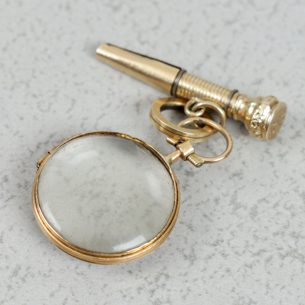 Fickursuppdragare och förstoringsglas, Guld, stål och glas